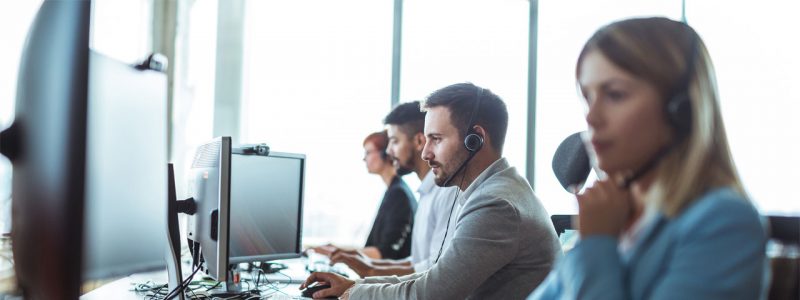 People working for IT support in front of their computers